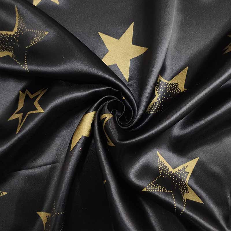 Tessuto Raso Carnevale Nero con Stelle Oro Image